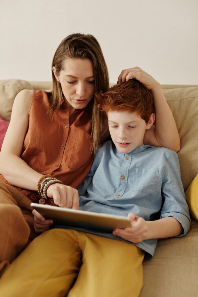 Woman and young boy using a tablet together at home
