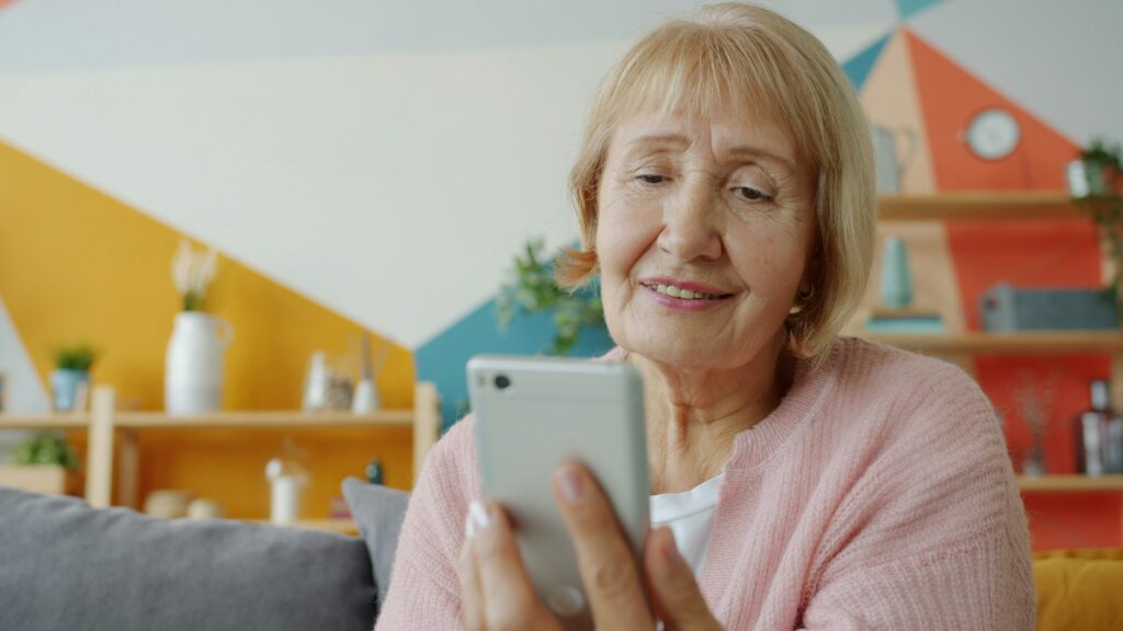Smiling senior woman using smartphone for Florida's free government phone program