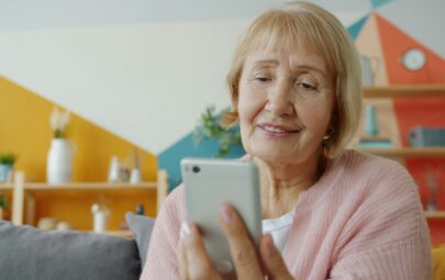 Smiling senior woman using smartphone for Florida's free government phone program